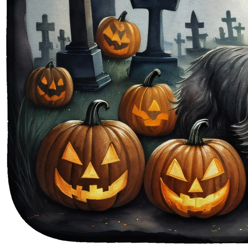 Carved pumpkins with glowing lights in a cemetery setting