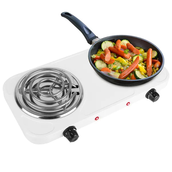 Portable electric stove with a frying pan containing vegetables on a white background