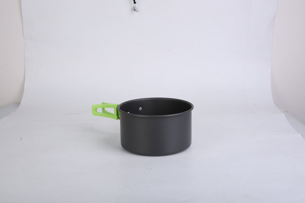 Black pot with a green handle on a white background