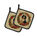 Two pot holders with a dog in a wreath design on a beige background