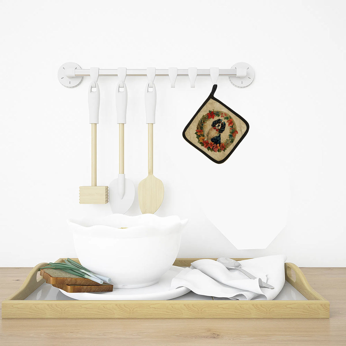 Set of kitchen utensils hanging on a rack with a pot holder featuring a dog design.