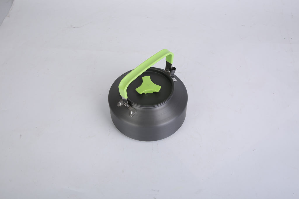 Small camping pot with a green handle on a white background
