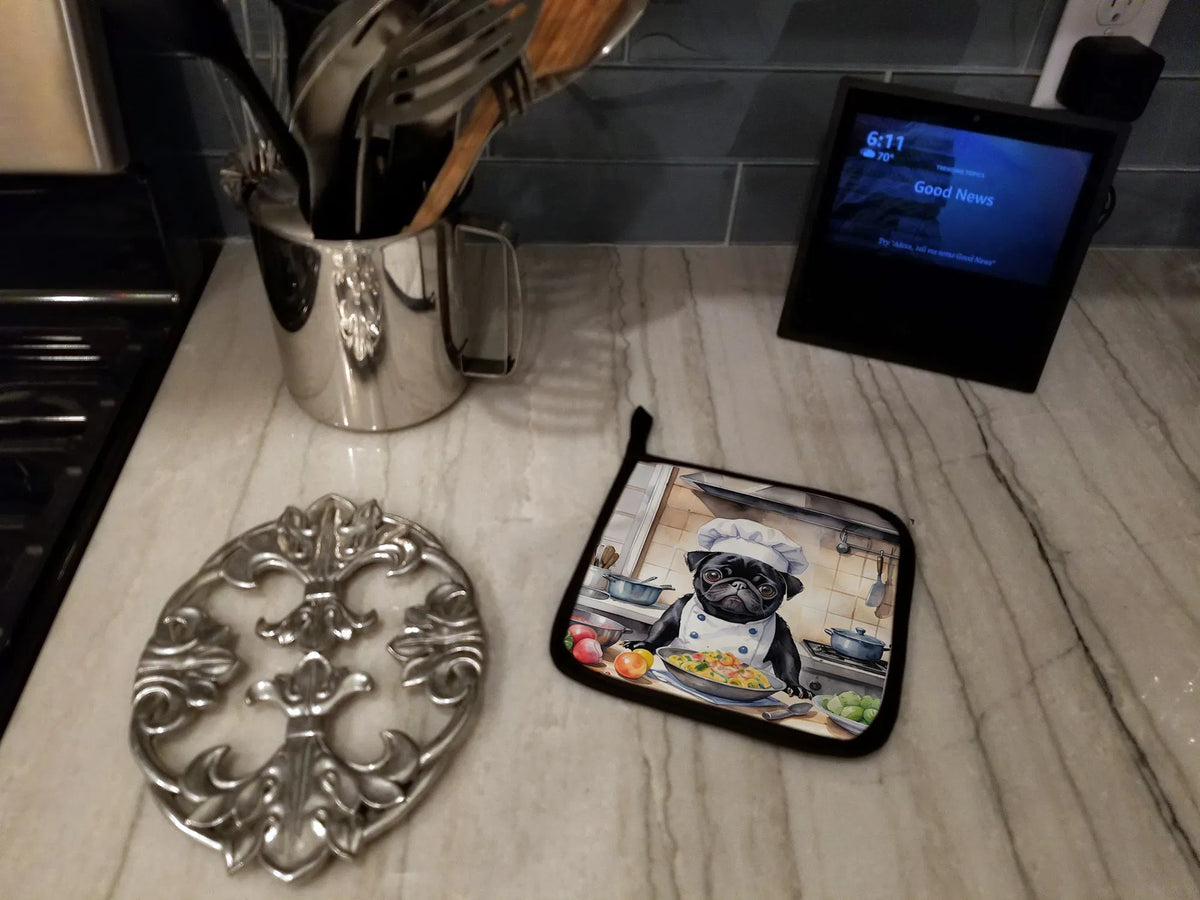 Kitchen counter with decorative trivet, pot holder with dog graphic, and digital clock.