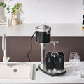 Dishwasher with a cleaning brush system on a kitchen counter.