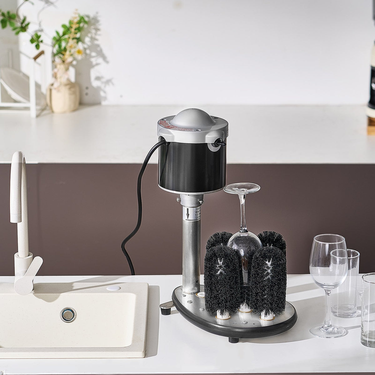 Dishwasher with a cleaning brush system on a kitchen counter.