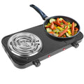 Portable electric stove with a frying pan containing vegetables on a white background