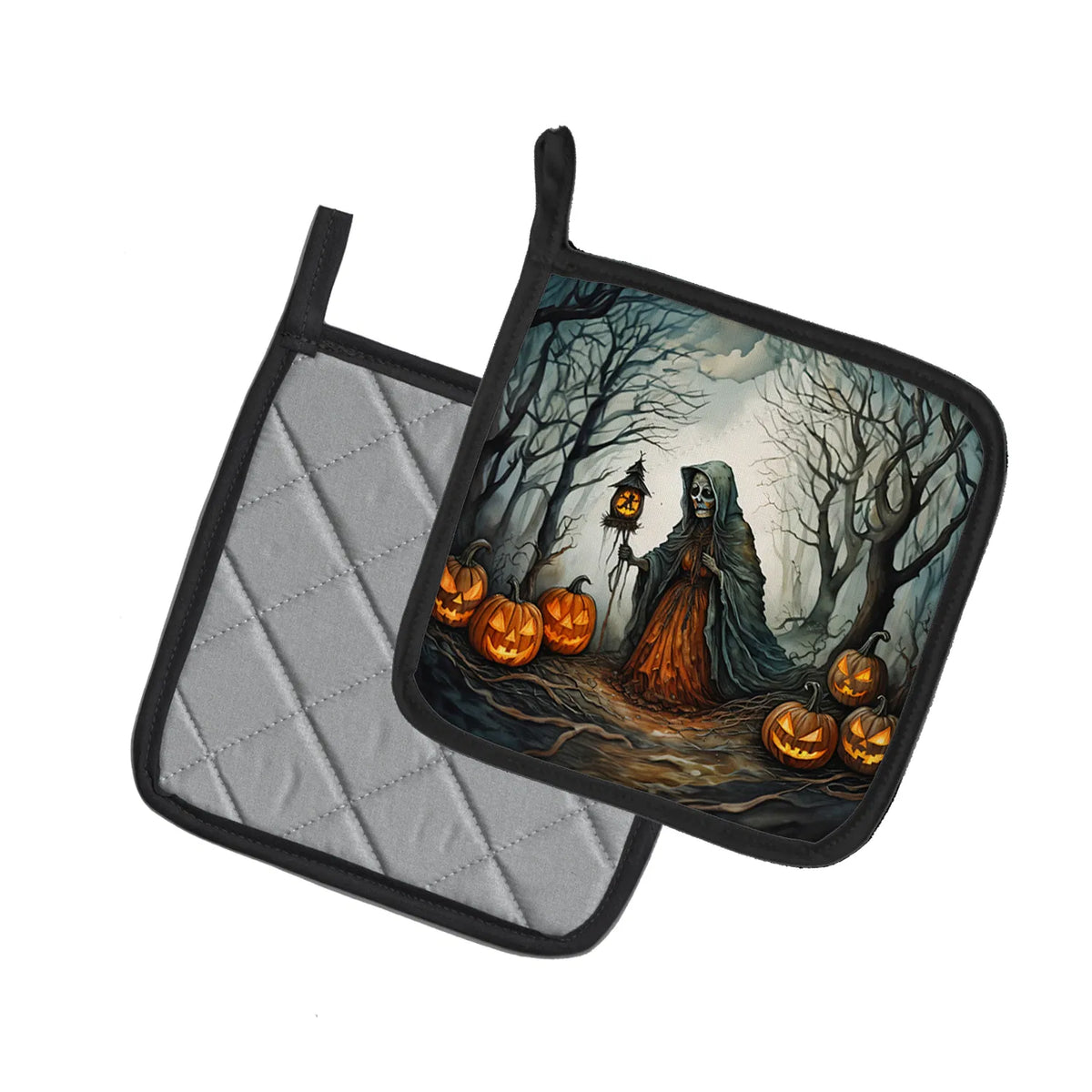 Two square pot holders with black trim on a white background. One pot holder shows a gray quilted fabric side, and the other shows a Halloween-themed printed design with a hooded figure, bare trees, and glowing jack-o'-lanterns.